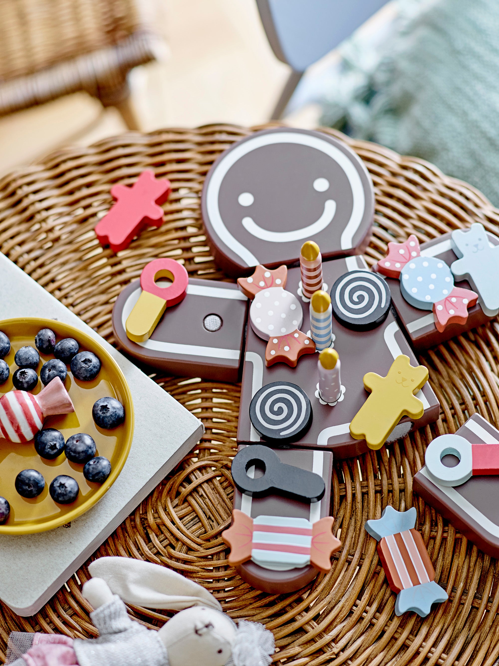 Traditional birthday cookie/cake shaped like a brown cartoonish stick figure with white lines and candy on top