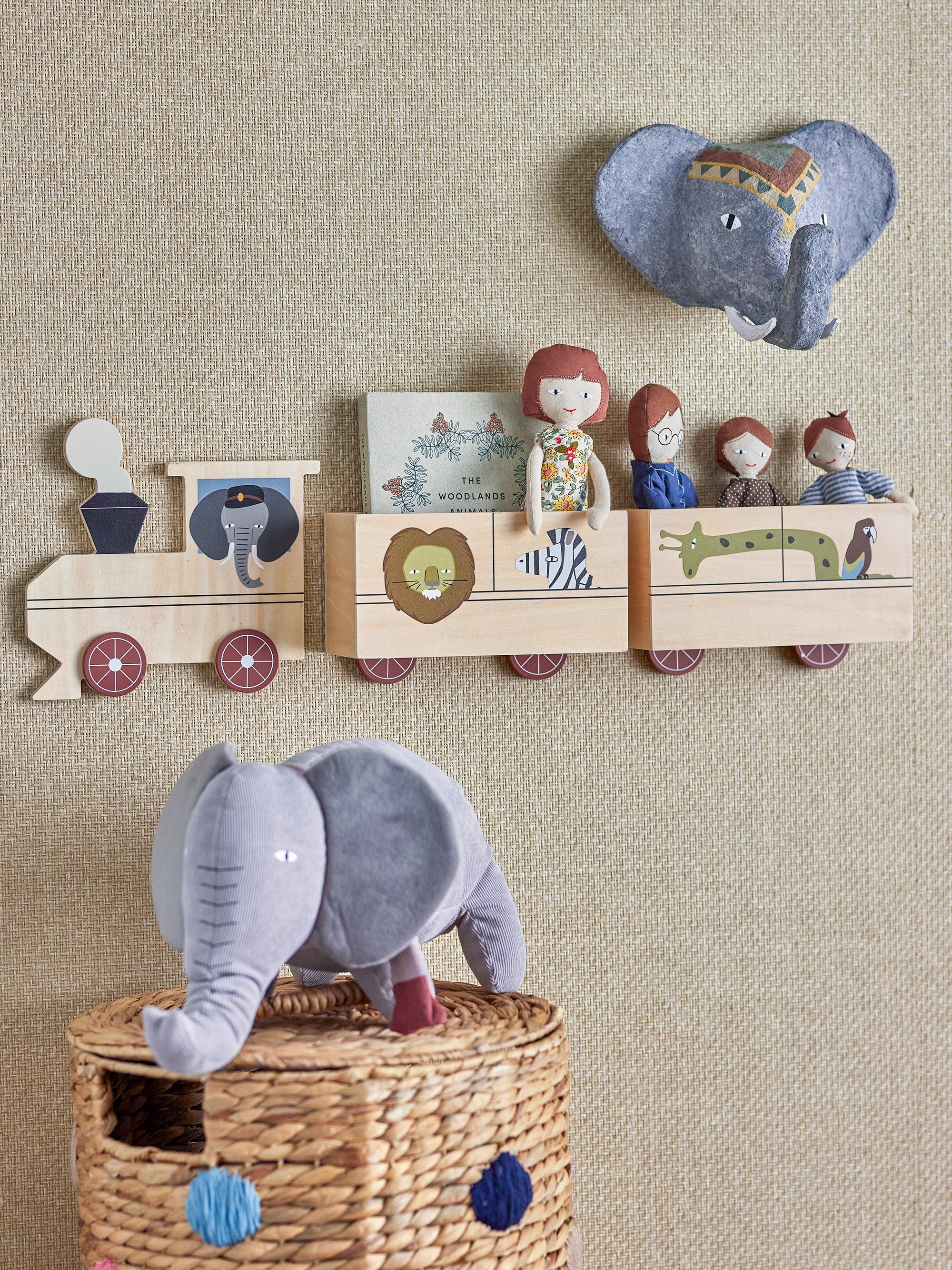 A safari-themed train with a doll family on board, and a plush toy shaped as an elephant