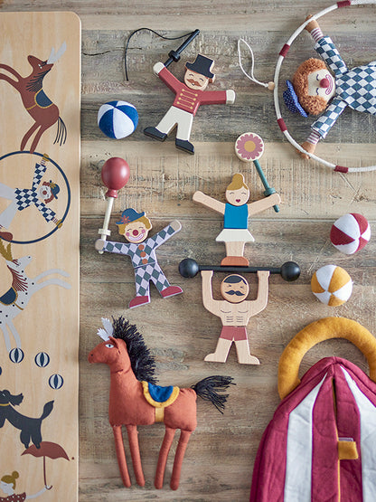 Circus themed wooden toys laying on a wooden table 