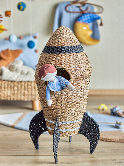 Basket made of rattan shaped as a rocket with a doll inside